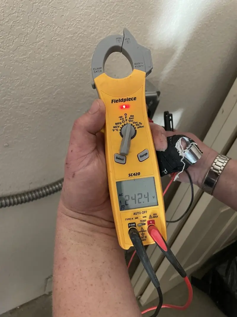 Voltage testing with clamp meter during Ceiling Fan Installation in Sacaton